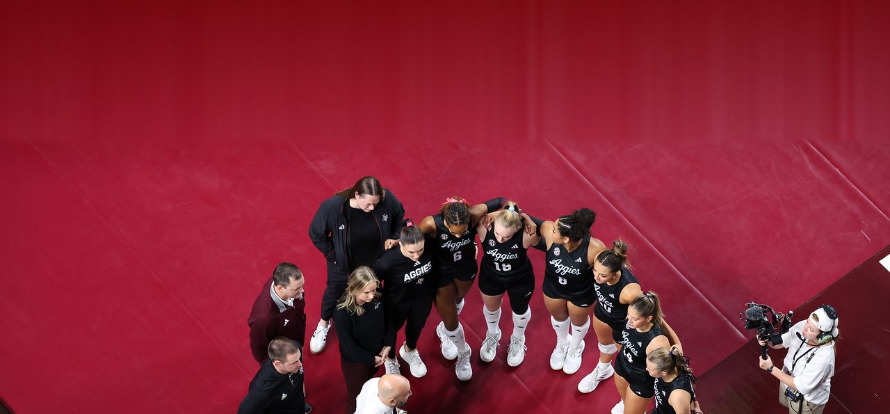 Texas A&M volleyball team huddled on the court